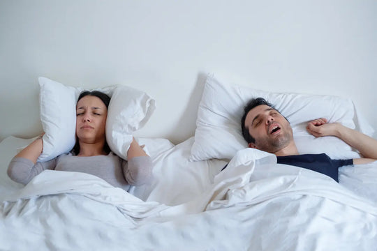 man snoring in bed